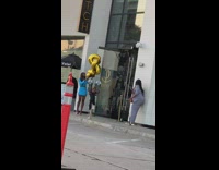 Girl poses with balloons outside restaurant 