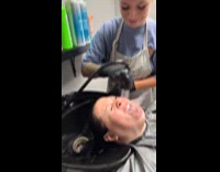 Woman aims faucet on customers mouth