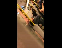 man on train rapping into orange container