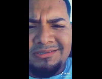 Guy holds Mexican flag outside car