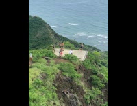 Woman cap grey top on helipad mountain