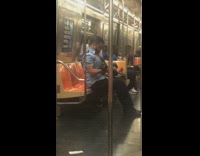 Guy blue shirt does bicep curls with back dumbbells on subway train