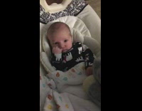 Baby boy black onesie flips girl off 