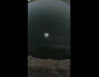 Drone footage of guy jumping off trampoline flip into water