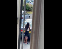 Woman tiktok dance behind the parked car