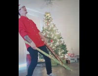 Guy hits tubes of wrapping paper together