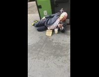 Guy dressed up as Donald Trump business suit with Mexican wall fund sign on sidewalk