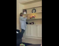 Mom takes photo of lit candle shelf 