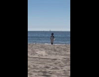 Woman white dress dances at the beach