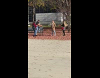 Man brown coat friends throw dried leaves