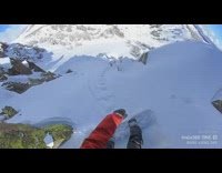 Guy rides white snowboard down steep mountain 