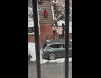 Woman red jacket sit stairs friends sidewalk