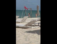 Two women in bikini take turns on the beach swing Part 1