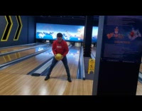 Guy throw bowling ball between legs lands strike