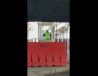 Guy wearing safety vest dances in booth 