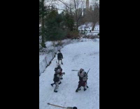 Four guys wearing knight costumes play fight 
