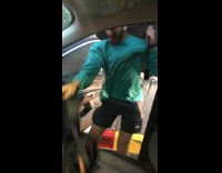 Guy in blue shirt gets blown by wind getting into car 