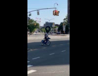 Cyclist on intersection balance tire on head