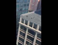 Woman dances on rooftop films Tiktok video