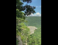 Woman try hand stand mountain top edge