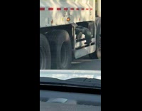 Collab WINY - Legs hang on the side of garbage truck