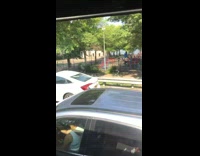 Woman drives through traffic with an ice cream cone on the roof of her car