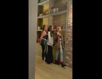 Three women bookshelf brick wall 