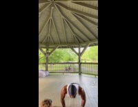Little boy joins man in workout at park 