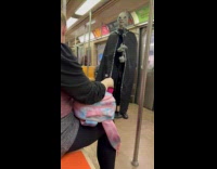Man wears alien costume talks inside subway