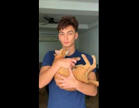 Guy picks up and cradles cat