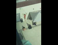 Lady in Red Bikini Leans against White Wall for Photo