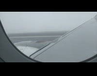 Airplane takes off flies through white clouds
