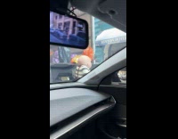 Men moves Alice in Wonderland props at sidewalk