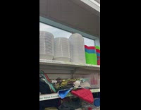 Birds on top of plastic containers on store shelf 