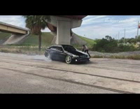 Black car smoke drift camera man follow