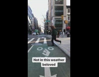 man crosses street bear head costume