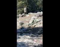 Collab IITW - Woman in white winter coat poses on the rocks