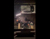 Collab WINY - Group of men film music video in front of an apartment flat