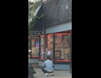 Woman gray cardigan drink pictorial tattoo shop