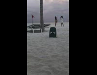 Woman pink bikini brown robe run beach