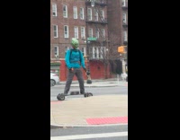 Man green goblin mask ride electric longboard