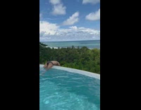 Guy hangs over pool edge as girl records his butt