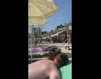 Green shorts guy poses public shower pool 