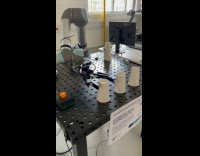 Person Controls Robot Arm to Pick Up Cup