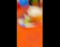 Dog wearing gold party hat eats candle 