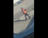 Airport runway traffic enforcer dances outside the window