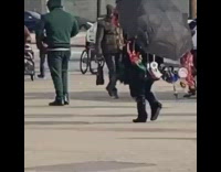 Umbrella covered in dream catchers walking