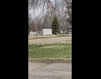 Woman in black dress lie down on top of the grave