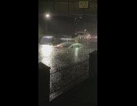 flooded cars sitting under freeway bridge