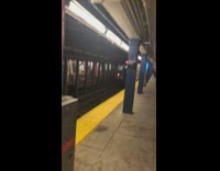 Guys hang off subway back